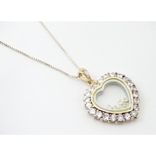 732A - A silver chain with heart shaped locket pendant set with white stones with further white stones with... 