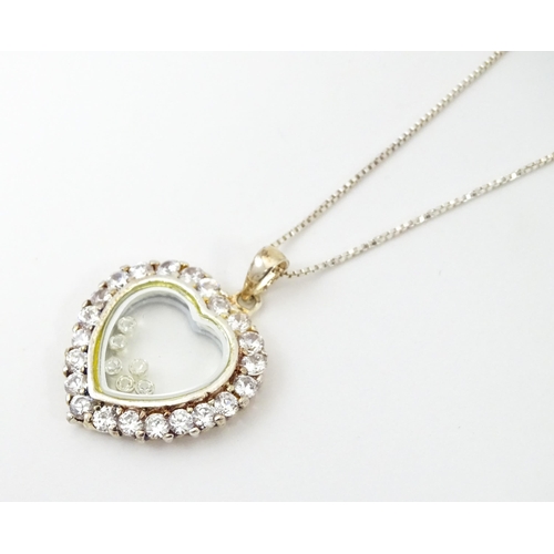 732A - A silver chain with heart shaped locket pendant set with white stones with further white stones with... 