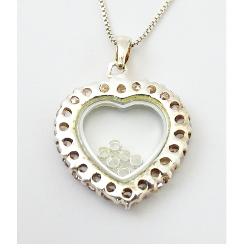 732A - A silver chain with heart shaped locket pendant set with white stones with further white stones with... 