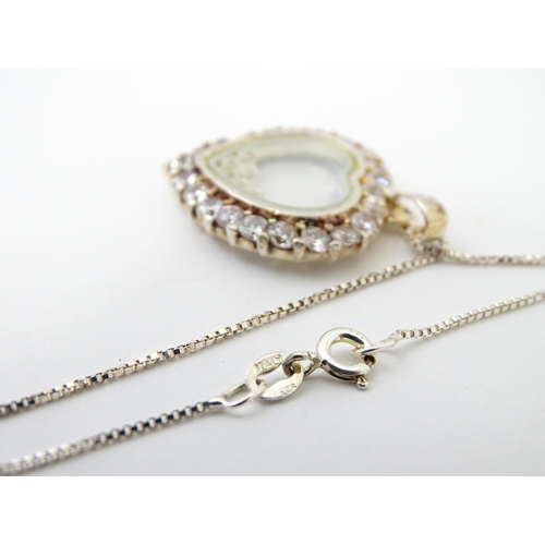 732A - A silver chain with heart shaped locket pendant set with white stones with further white stones with... 