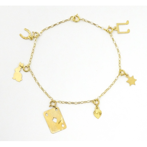 736A - A 9ct gold bracelet set with various charms to include horse shoe, ace of spades, rabbit, etc. Appro... 