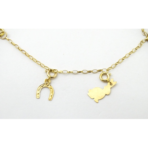 736A - A 9ct gold bracelet set with various charms to include horse shoe, ace of spades, rabbit, etc. Appro... 