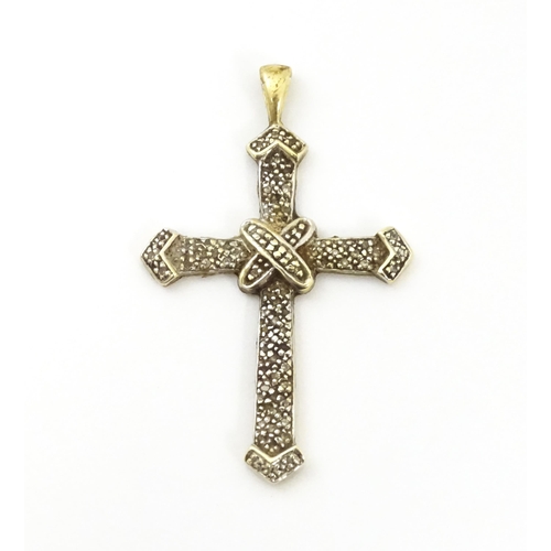 740A - A 9ct gold pendant of cross form with chip set diamonds. Approx. 1 3/4