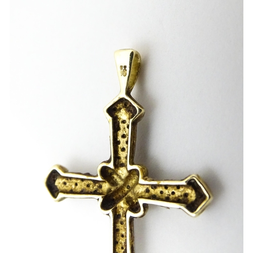 740A - A 9ct gold pendant of cross form with chip set diamonds. Approx. 1 3/4