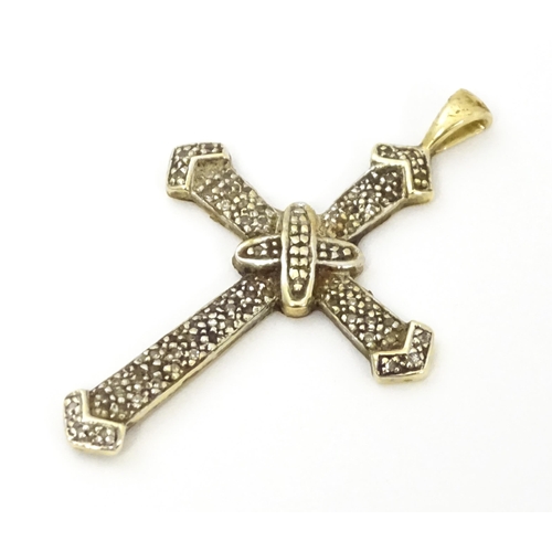 740A - A 9ct gold pendant of cross form with chip set diamonds. Approx. 1 3/4