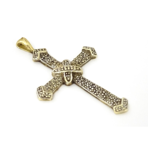 740A - A 9ct gold pendant of cross form with chip set diamonds. Approx. 1 3/4