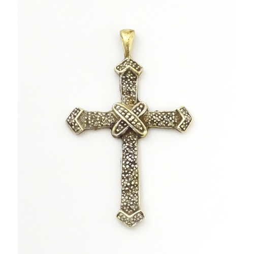 740A - A 9ct gold pendant of cross form with chip set diamonds. Approx. 1 3/4