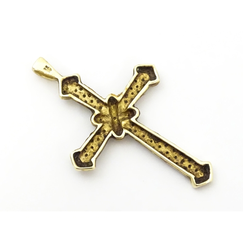 740A - A 9ct gold pendant of cross form with chip set diamonds. Approx. 1 3/4