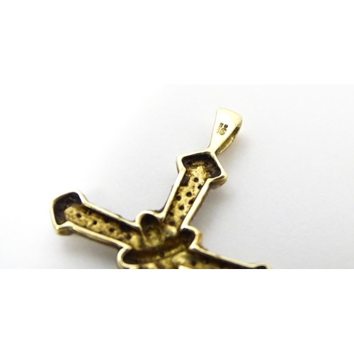 740A - A 9ct gold pendant of cross form with chip set diamonds. Approx. 1 3/4