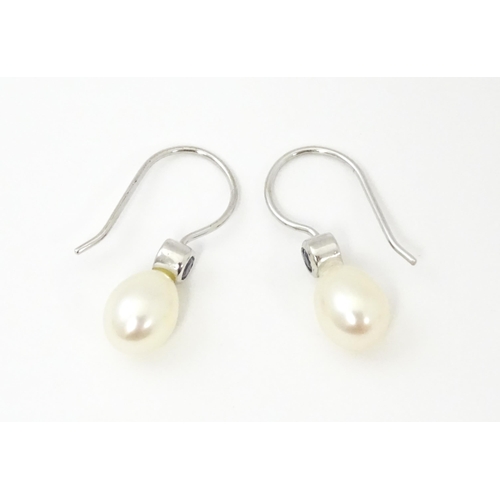 751A - A 14ct white gold drop earrings set with pearls and pale blue stones. Approx. 3/4