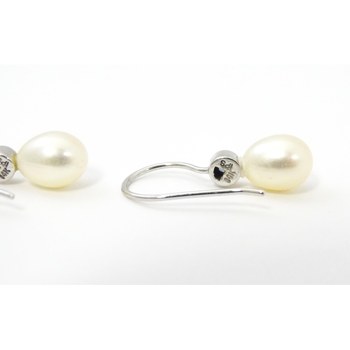 751A - A 14ct white gold drop earrings set with pearls and pale blue stones. Approx. 3/4