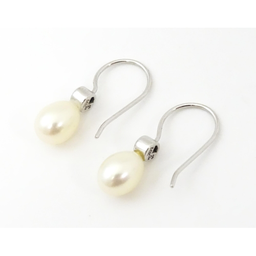 751A - A 14ct white gold drop earrings set with pearls and pale blue stones. Approx. 3/4