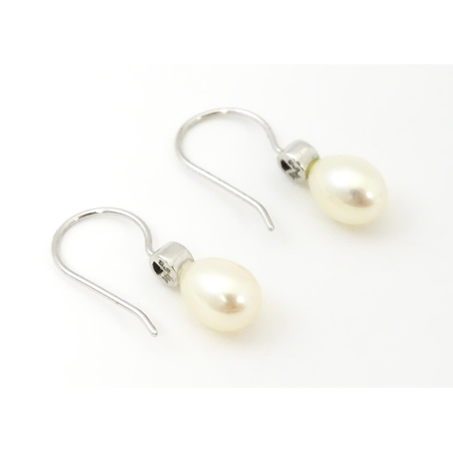 751A - A 14ct white gold drop earrings set with pearls and pale blue stones. Approx. 3/4