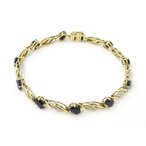 752A - A 9ct gold bracelet set with sapphires and diamonds. Approx. 7