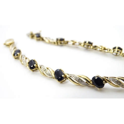 752A - A 9ct gold bracelet set with sapphires and diamonds. Approx. 7