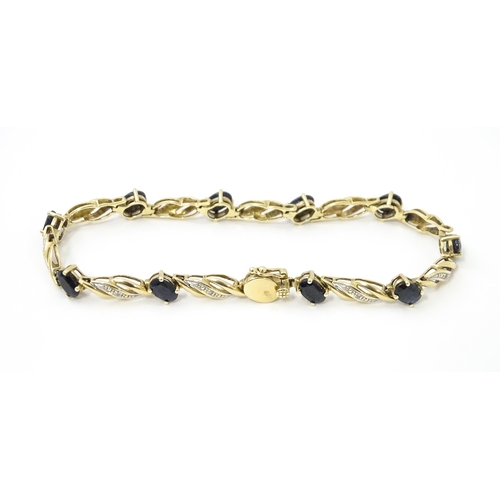 752A - A 9ct gold bracelet set with sapphires and diamonds. Approx. 7