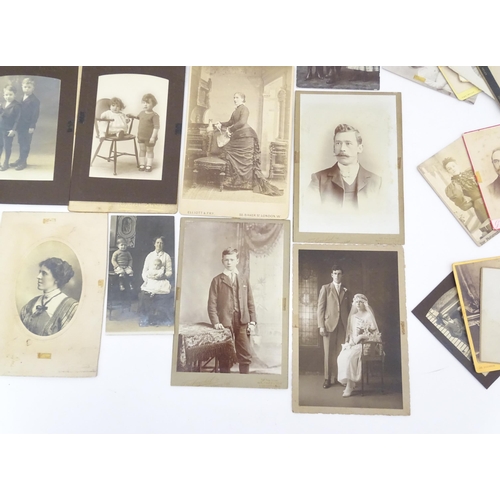 2144 - A quantity of assorted 19thC and later studio photograph cards / carte de visite type photographs to... 