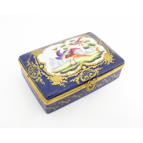 82 - A French porcelain box of rectangular form the cobalt blue ground with gilt decoration, the lid with... 