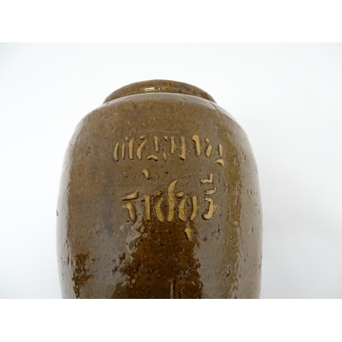 96 - A stoneware vase / pot of tapering form with script detail. Approx. 6 1/4