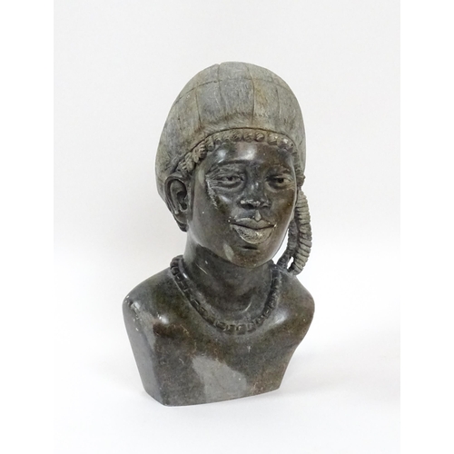 1151 - Ethnographic / Native / Tribal : An African carved soapstone bust modelled as a woman wearing a bonn... 