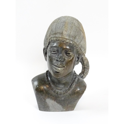 1151 - Ethnographic / Native / Tribal : An African carved soapstone bust modelled as a woman wearing a bonn... 