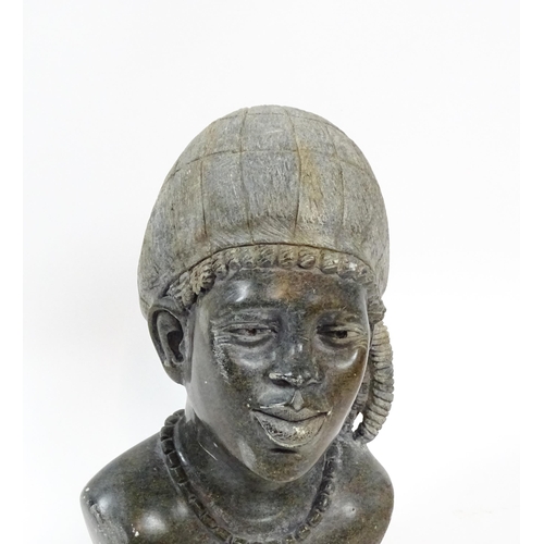 1151 - Ethnographic / Native / Tribal : An African carved soapstone bust modelled as a woman wearing a bonn... 