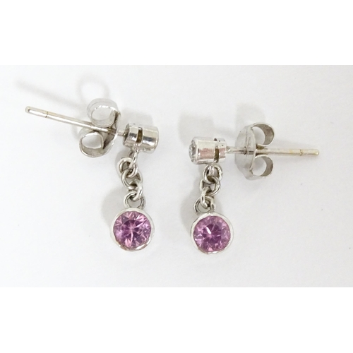 733A - A pair of white gold drop earrings set with diamonds with pink sapphire drops. Approx. 1/2