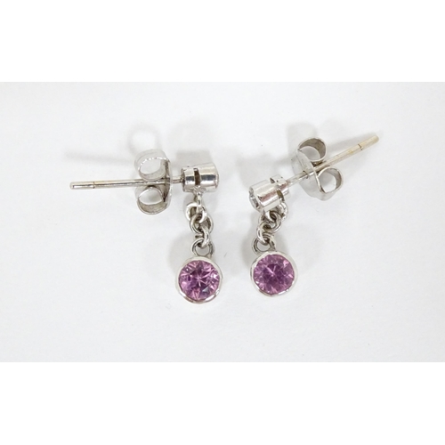 733A - A pair of white gold drop earrings set with diamonds with pink sapphire drops. Approx. 1/2