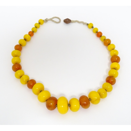 760A - A vintage necklace of graduated amber beads. Approx 24