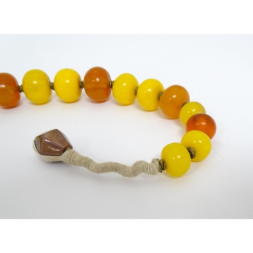 760A - A vintage necklace of graduated amber beads. Approx 24