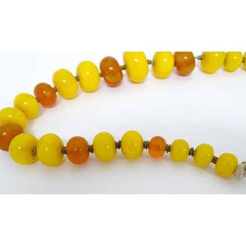 760A - A vintage necklace of graduated amber beads. Approx 24