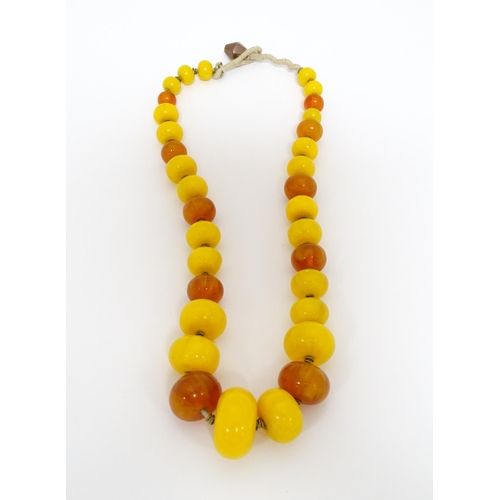 760A - A vintage necklace of graduated amber beads. Approx 24