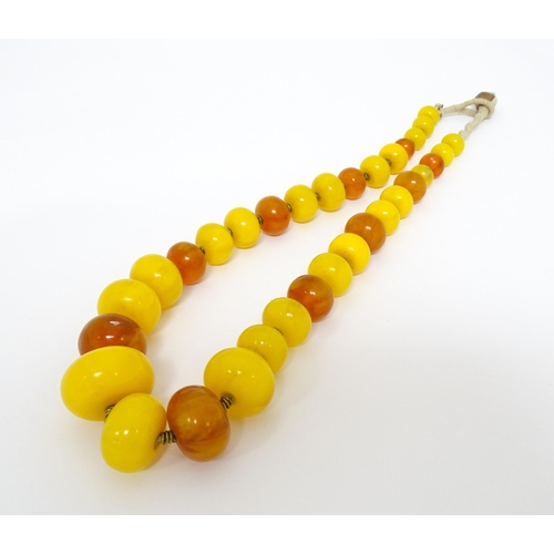 760A - A vintage necklace of graduated amber beads. Approx 24