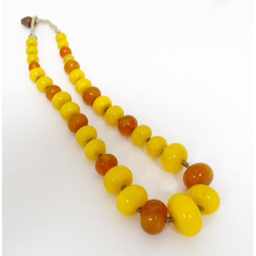 760A - A vintage necklace of graduated amber beads. Approx 24