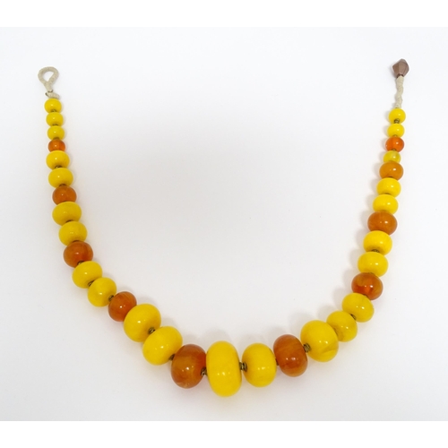 760A - A vintage necklace of graduated amber beads. Approx 24