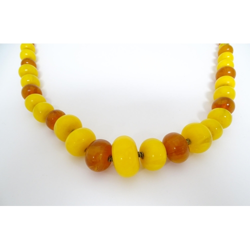 760A - A vintage necklace of graduated amber beads. Approx 24