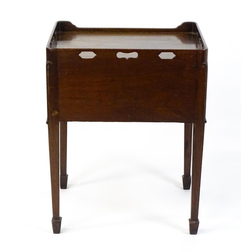 1491 - An 18thC mahogany bedside table / tray top cabinet with a pierced upstand above two hinged doors and... 