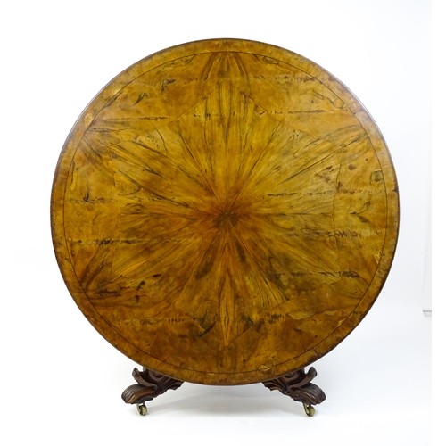 1493 - A 19thC dining table with an olive wood veneered circular top raised on a rosewood pedestal with aca... 