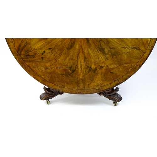 1493 - A 19thC dining table with an olive wood veneered circular top raised on a rosewood pedestal with aca... 