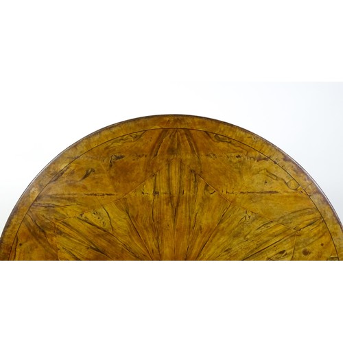 1493 - A 19thC dining table with an olive wood veneered circular top raised on a rosewood pedestal with aca... 