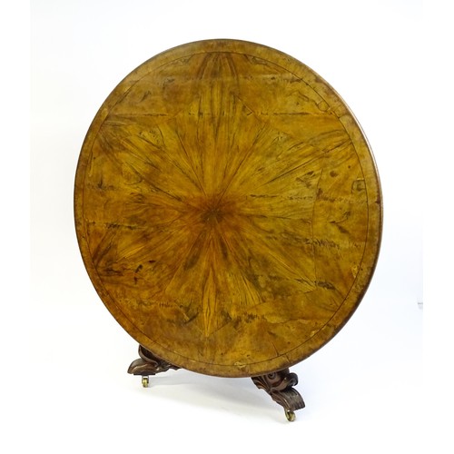 1493 - A 19thC dining table with an olive wood veneered circular top raised on a rosewood pedestal with aca... 