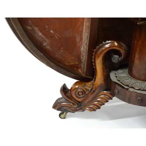 1493 - A 19thC dining table with an olive wood veneered circular top raised on a rosewood pedestal with aca... 