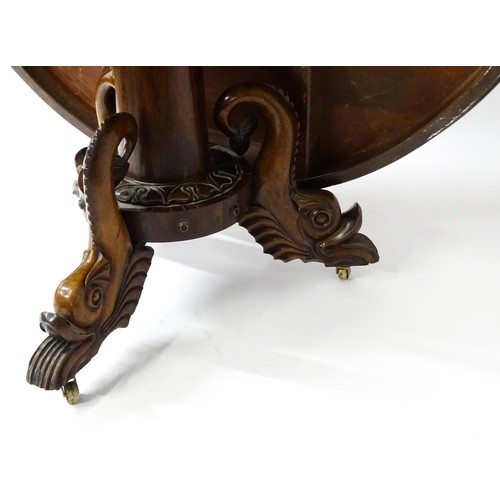 1493 - A 19thC dining table with an olive wood veneered circular top raised on a rosewood pedestal with aca... 