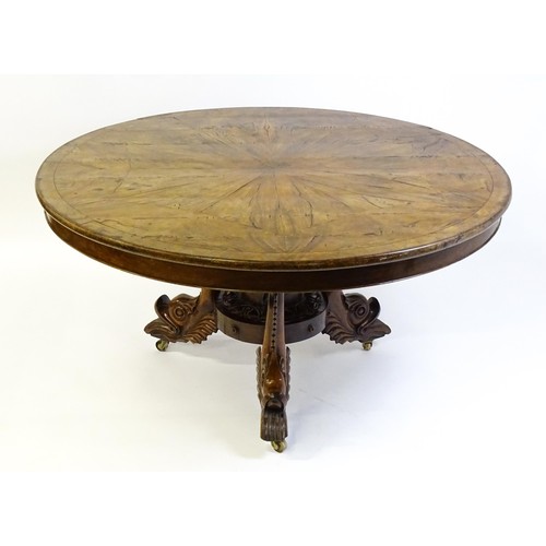 1493 - A 19thC dining table with an olive wood veneered circular top raised on a rosewood pedestal with aca... 