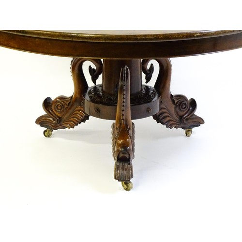 1493 - A 19thC dining table with an olive wood veneered circular top raised on a rosewood pedestal with aca... 