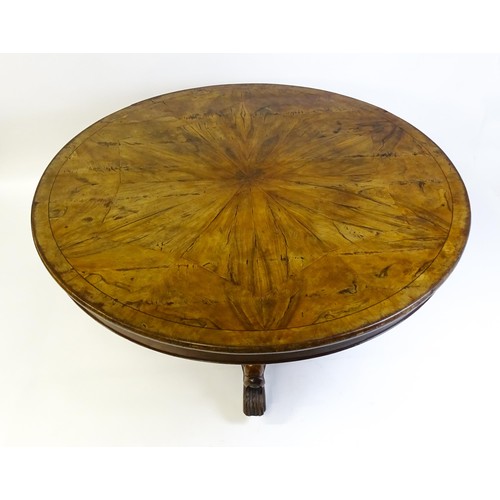 1493 - A 19thC dining table with an olive wood veneered circular top raised on a rosewood pedestal with aca... 