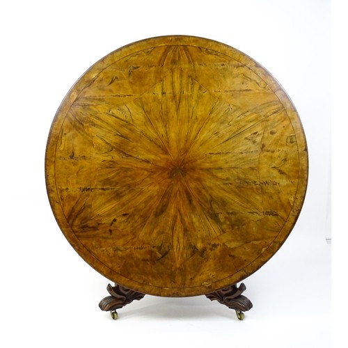 1493 - A 19thC dining table with an olive wood veneered circular top raised on a rosewood pedestal with aca... 