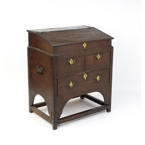 1511 - An early / mid 18thC mahogany clerks desk with a hinged sloping lid opening to show a fitted interio... 