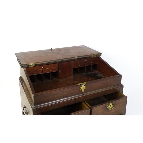 1511 - An early / mid 18thC mahogany clerks desk with a hinged sloping lid opening to show a fitted interio... 