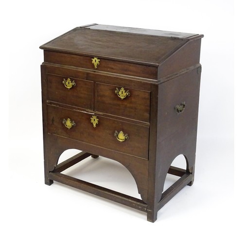 1511 - An early / mid 18thC mahogany clerks desk with a hinged sloping lid opening to show a fitted interio... 